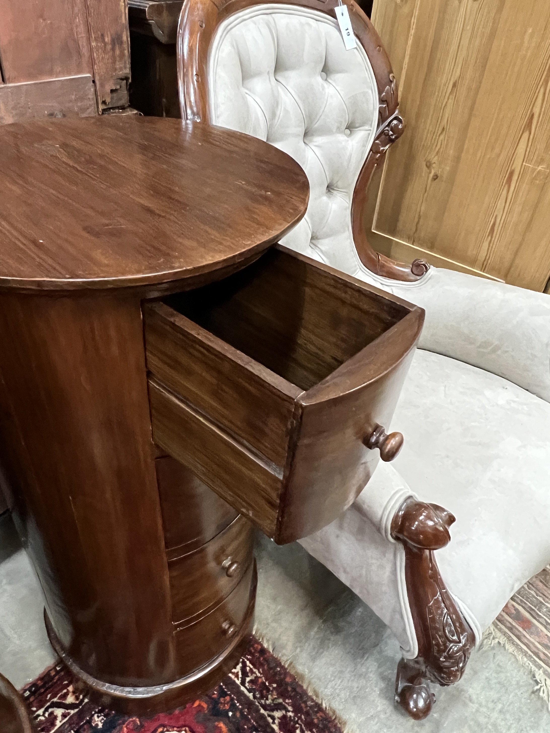 A pair of reproduction mahogany cylindrical bedside cupboards, each fitted four small drawers, diameter 41cm, height 85cm